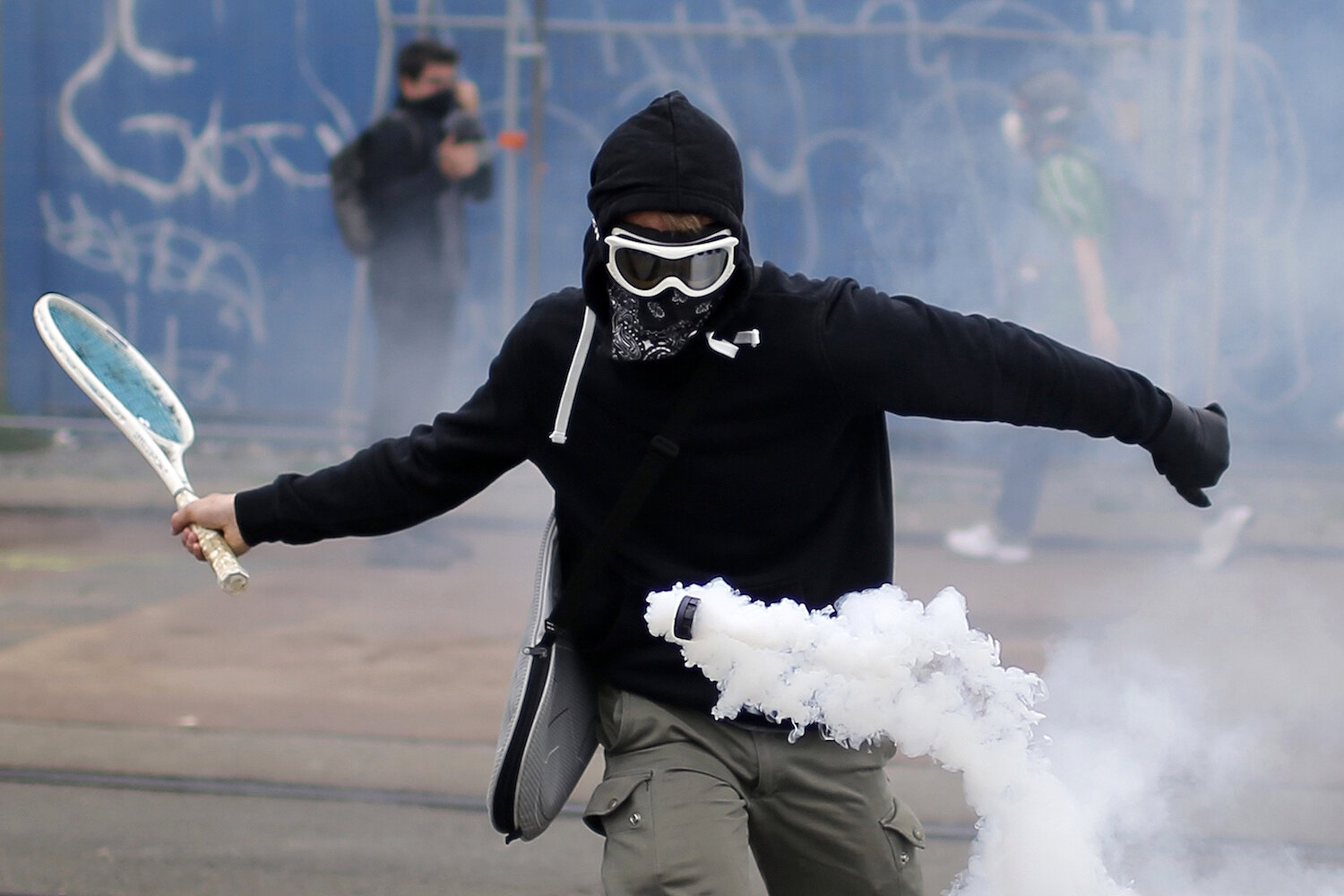 <p>2 июня. Нант, Франция.&nbsp;Протестующий использует ракетку, чтобы отбросить назад слезоточивый газ во время акции против предложенных правительство реформ трудового права.</p>