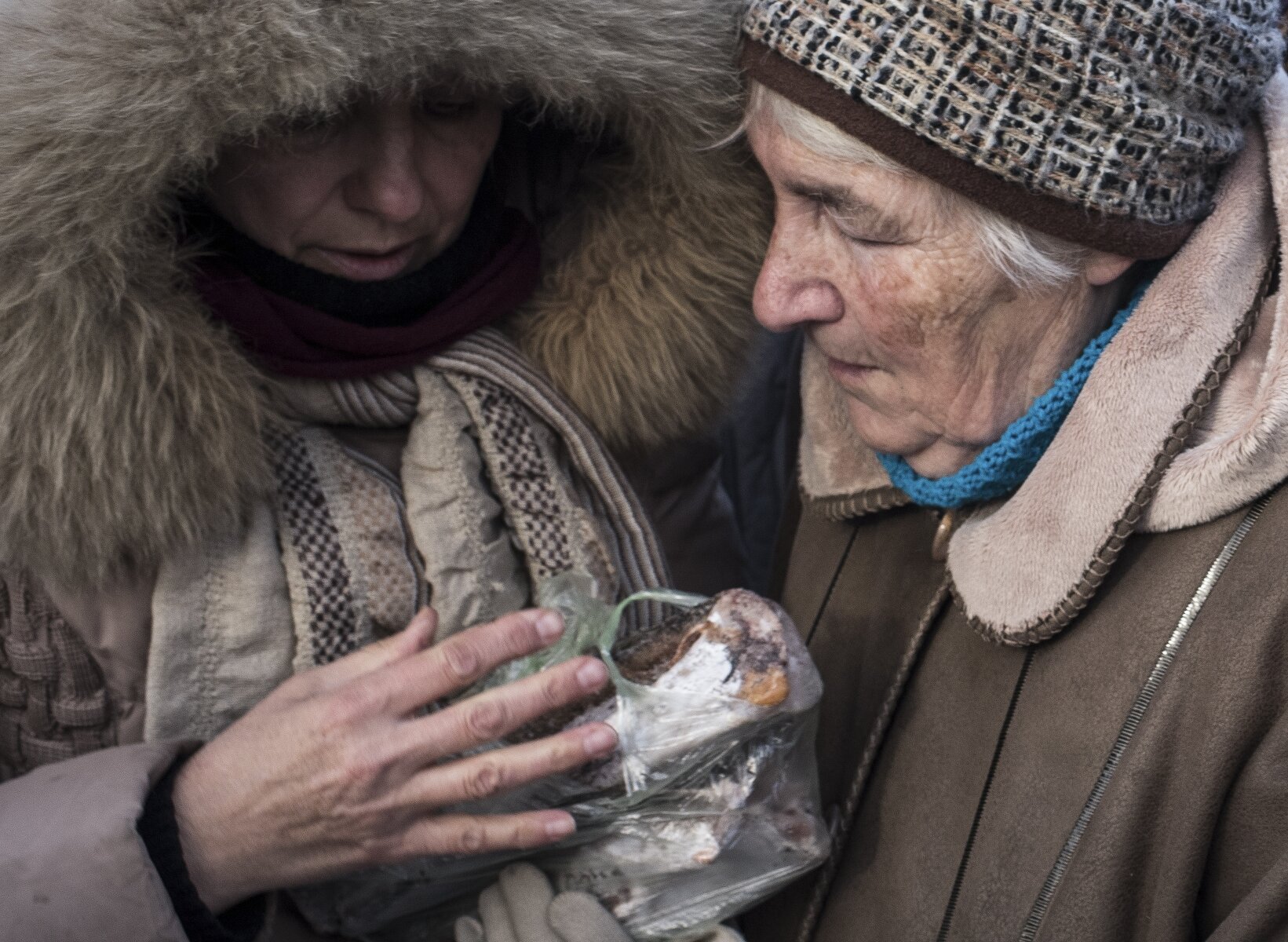 <p>Женщины держат в руках бесплатную еду в одном из центров по оказанию гуманитарной помощи в Авдеевке. Замерзшие жители&nbsp;города&nbsp;без электричества и отопления&nbsp;начали собираться в специально организованных гуманитарных центрах, чтобы получить пищу и согреться.<br />
&nbsp;</p>