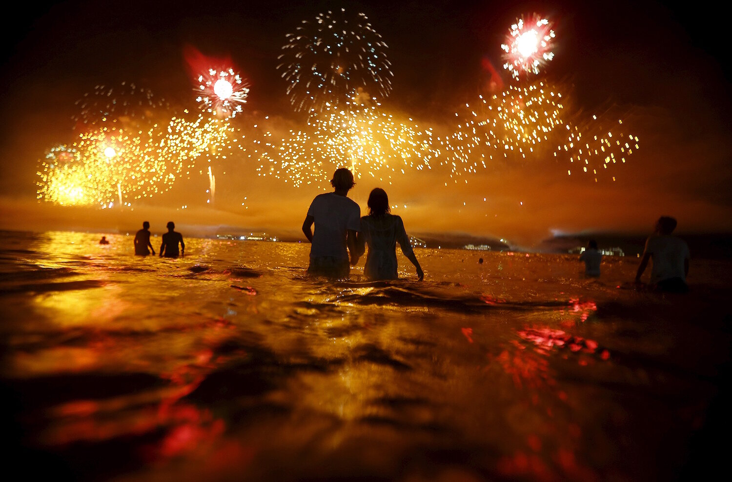 <p>1 января. Рио-де-Жанейро, Бразилия.&nbsp;Люди наблюдают за праздничным фейерверком на пляже Копакабана во время празднования Нового года.</p>